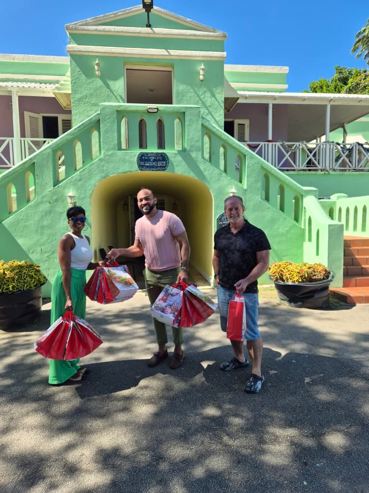 Asokore Beckles delivering a Christmas donation on behalf of the Village Foundation to Vedun House, 2025